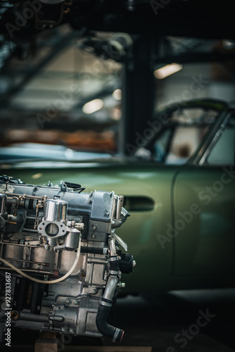 Newly restored engine for a classic car in a background stored in a vintage car restauration garage.