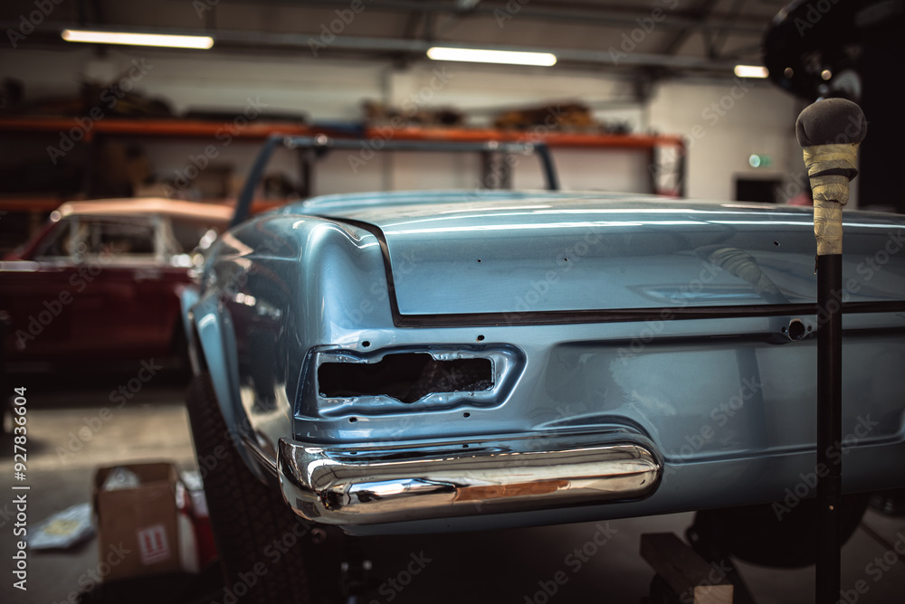 Fototapeta premium Classic cars being restored in a vintage vehicle garage workshop