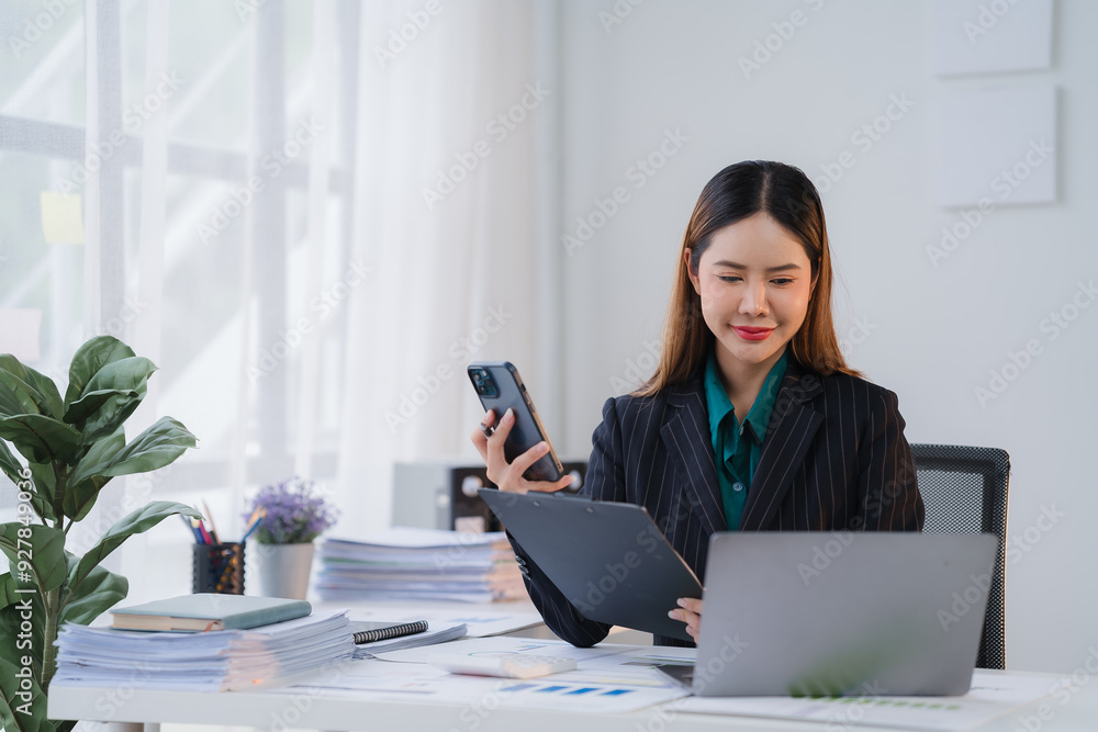 Focused Asian Businesswoman Multitasking at Work Focused Asian Businesswoman Multitasking at Work