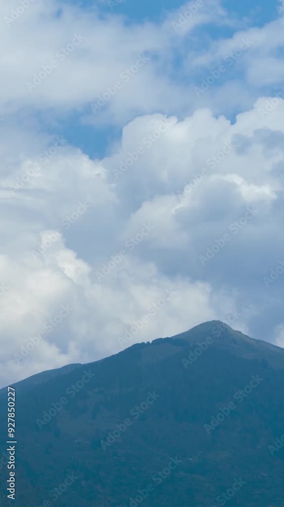 Vertical Time lapse shot of dark monsoon stormy clouds above the Himalayan mountain range as seen from Naggar town near Manali in Himachal Pradesh, India. Dark clouds bringing rain to the mountains. Vertical Time lapse shot of dark monsoon stormy clouds above the Himalayan mountain range as seen from Naggar town near Manali in Himachal Pradesh, India. Dark clouds bringing rain to the mountains.
