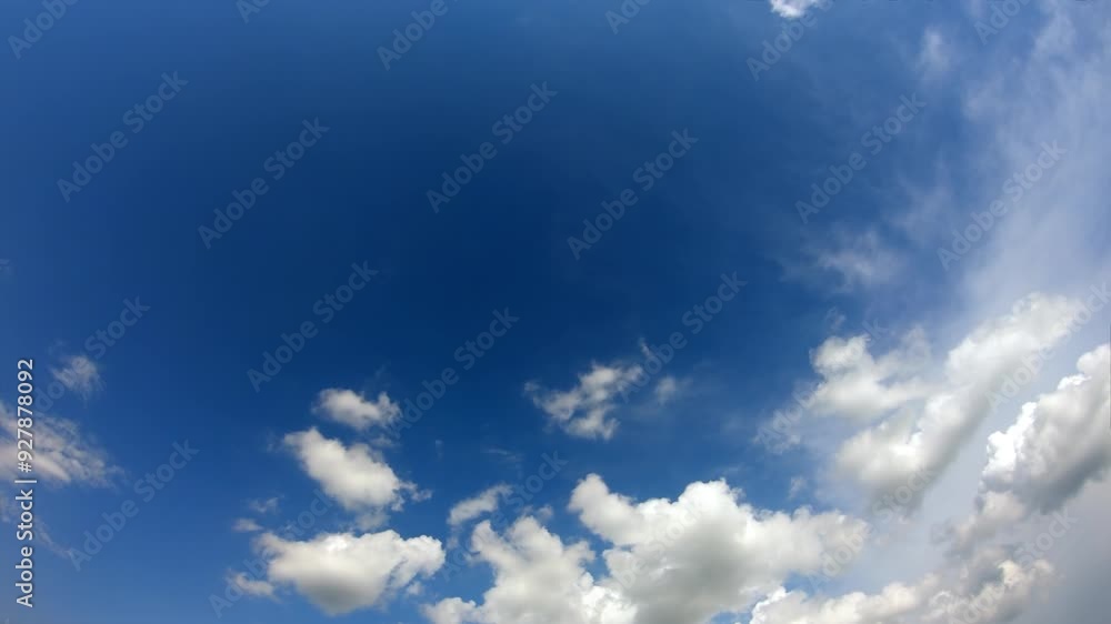 A serene expanse of blue sky is accentuated by intricate patterns of white clouds. A serene expanse of blue sky is accentuated by intricate patterns of white clouds.
