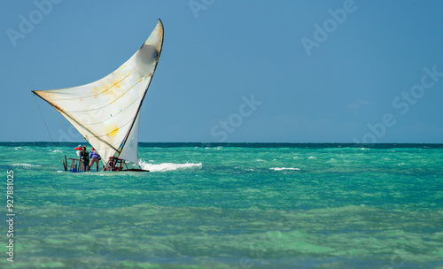 Fotografie Jangada, or raft, a rustic wooden boat with a sail, typically used for fishing and recently for excursions with tourists