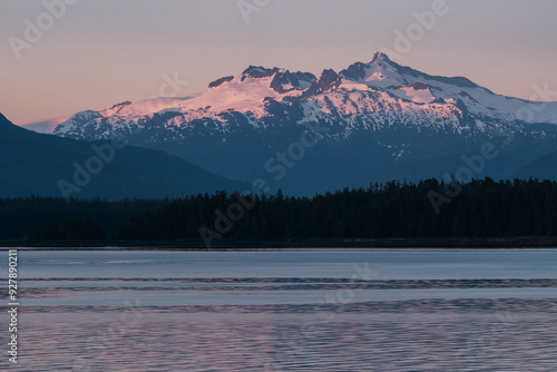 Sunset on mountain range along Southeast Alaskan coastline along the inside passage in summer