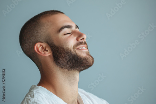 A close up of a man's face with his eyes closed