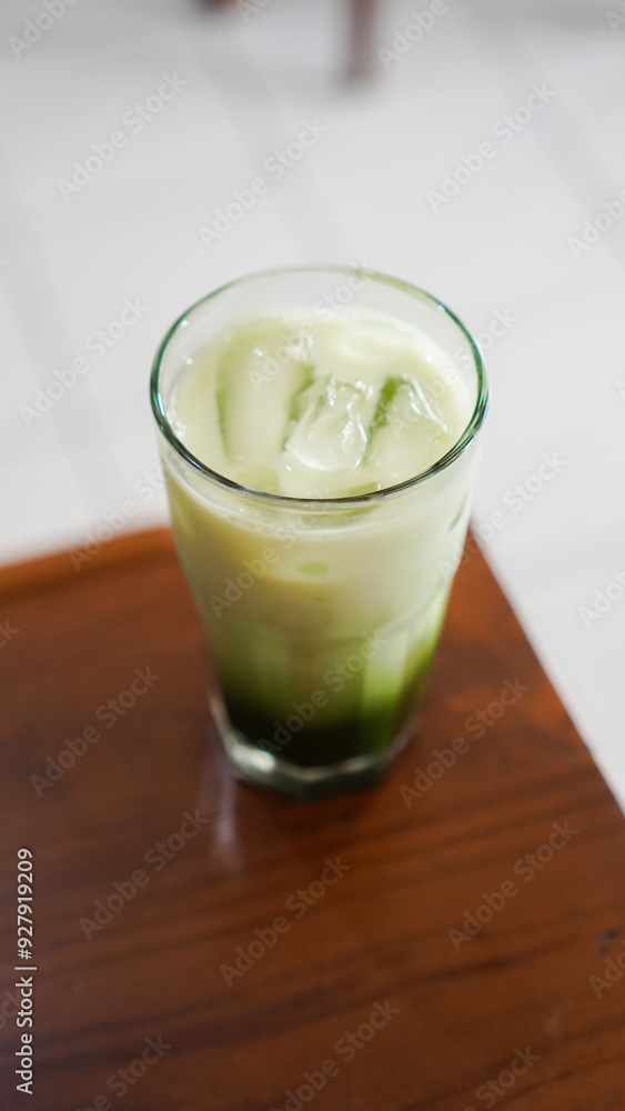 a glass of fresh matcha flavored ice served on a table in a cafe a glass of fresh matcha flavored ice served on a table in a cafe