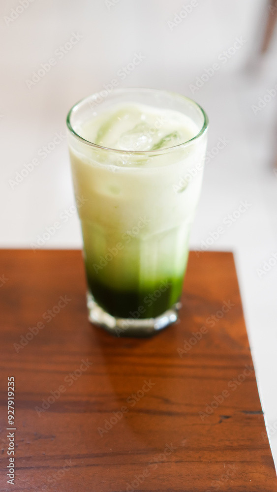 a glass of fresh matcha flavored ice served on a table in a cafe a glass of fresh matcha flavored ice served on a table in a cafe