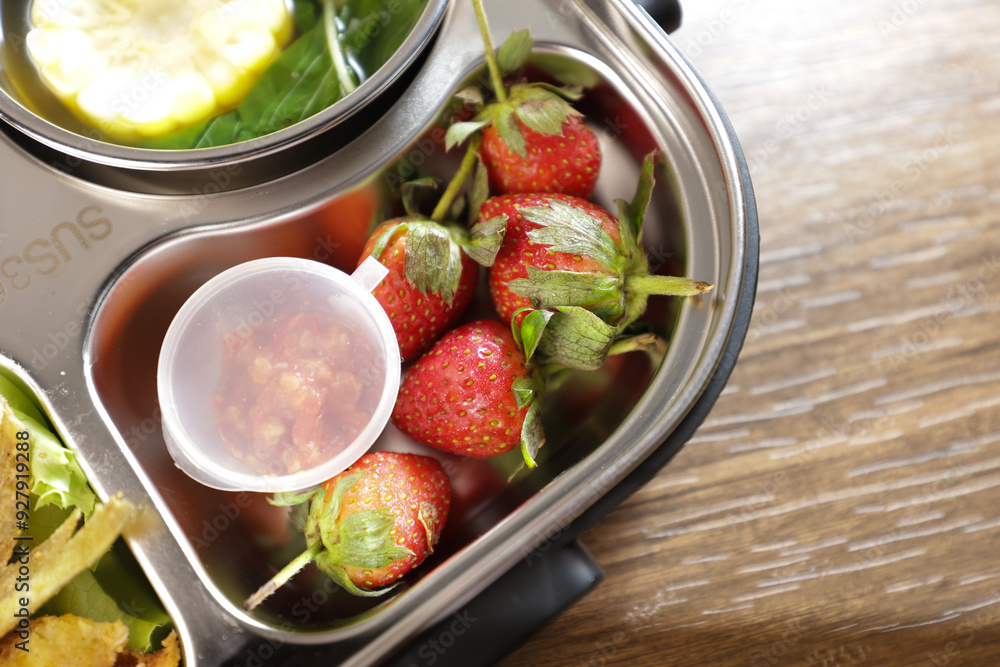 Lunch or bento is put in a lunch box. There are vegetables, side dishes, fruit and also rice. Lunch or bento is put in a lunch box. There are vegetables, side dishes, fruit and also rice.
