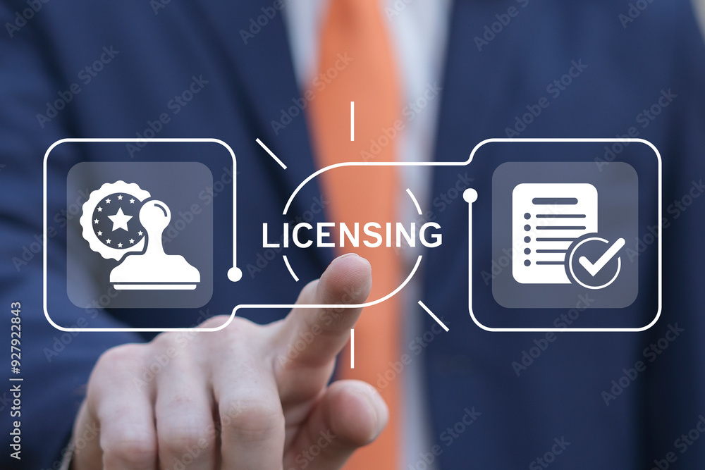 Business man using virtual touch interface presses word: LICENSING. License agreement business technology concept. Copyright protection law license property rights.