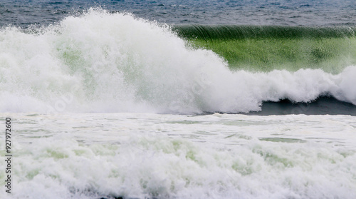 Large Ocean Wave breaking over its funnel photo