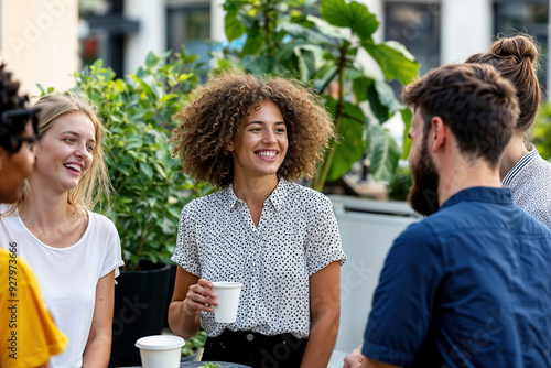 Group of business people enjoying coffee outdoors in sunlight