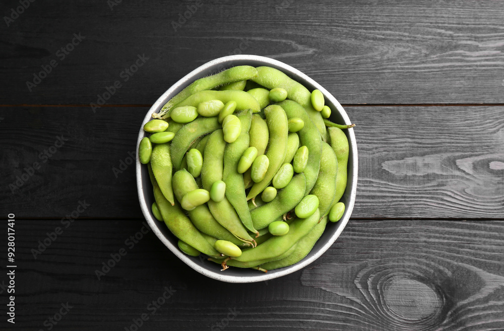 Raw green edamame soybeans and pods on wooden table, top view Raw green edamame soybeans and pods on wooden table, top view