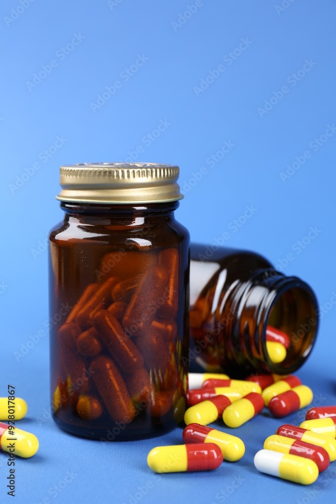 Pharmacist. Pills in plastic bottles on blue background Pharmacist. Pills in plastic bottles on blue background