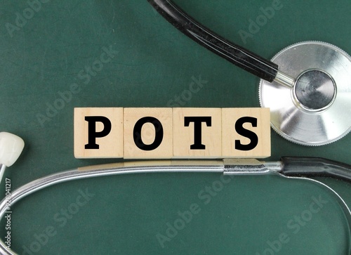 stethoscope and the letters POTS or the word Postural Orthostatic Tachycardia Syndrome. symptoms when you transition from lying down to standing up