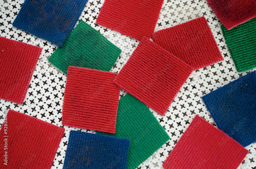 Fototapeta premium Square coasters in different colors made from carpet