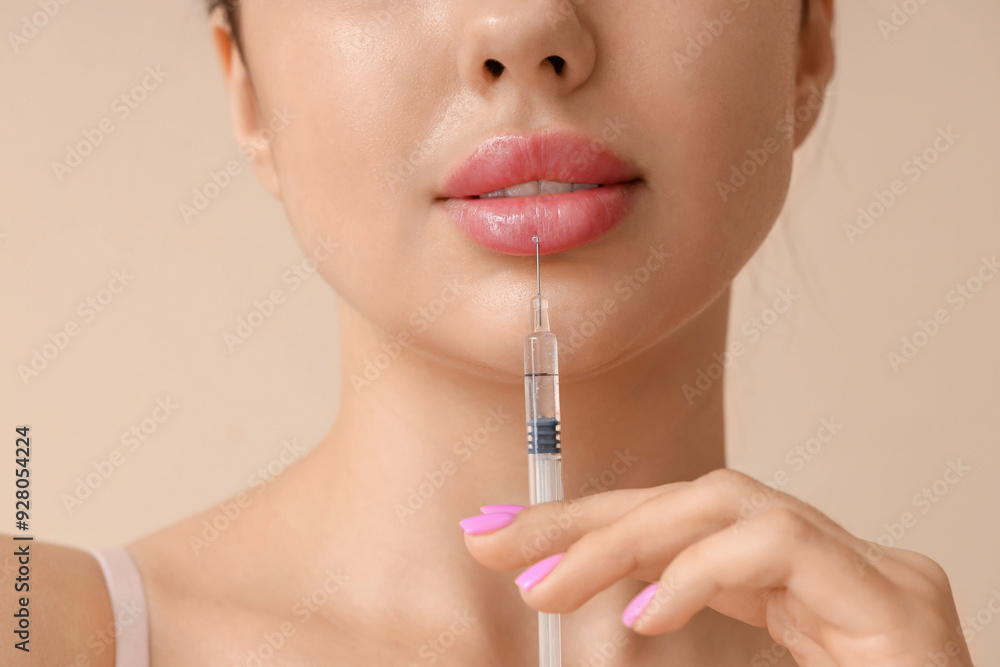 Young woman with lip injection on beige background, closeup Young woman with lip injection on beige background, closeup