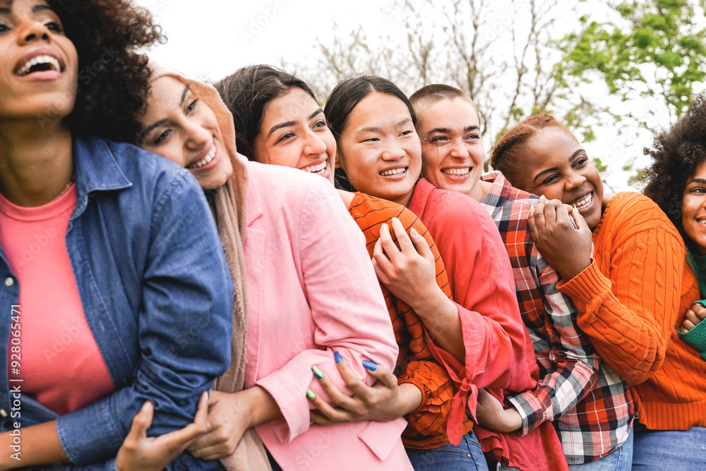 Fototapeta premium Multicultural, Group of diverse young women friends hugging together at park city. Happy people celebrating party outside