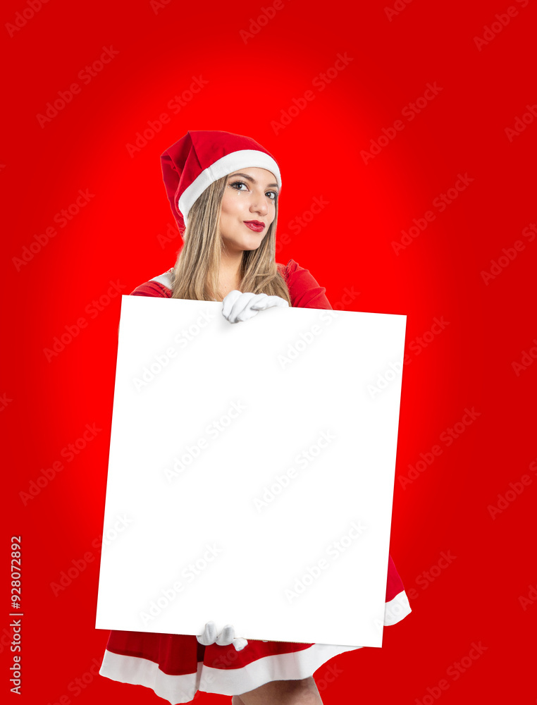 Young blonde woman Santa Claus showing a sign with copy space looking at camera Young blonde woman Santa Claus showing a sign with copy space looking at camera
