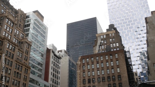 New York City Manhattan Midtown building architecture, urban street in United States. Residential houses with apartments, real estate property on 5th Fifth 5 avenue, realty in USA. Water tower tank. photo