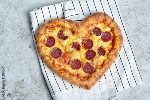 Beautiful and delicious pepperoni pizza in the shape of a heart