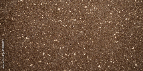 Brown background showing a rough textured surface with white specks