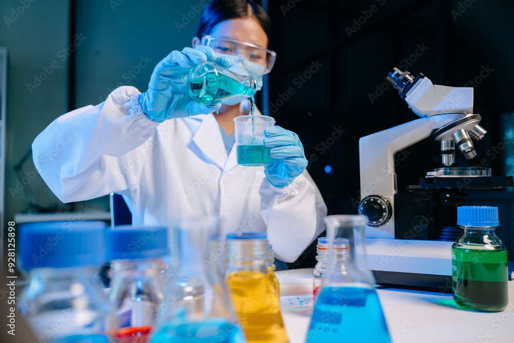 Fototapeta premium Scientist mixing chemical liquids in the chemistry lab. Researcher working