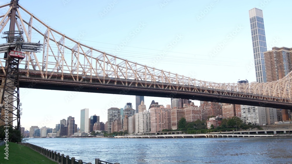 Naklejka premium New York City waterfront skyline, Queensboro Bridge, Manhattan Midtown buildings, riverfront skyscrapers. Waterside cityscape view from Roosevelt Island. United States architecture and real estate.