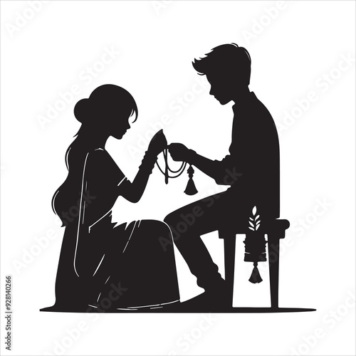 Young indian girl tying rakhi to brother hand during raksha bandhan festival