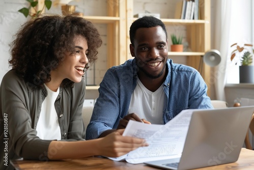 Happy Couple Discussing Finances and Looking at Laptop