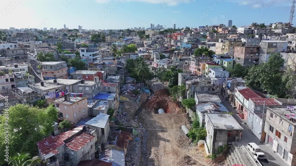 Construction site on street of poor Herrera District with poverty. Housing Area with destroyed low class buildings. Aerial forward wide shot. Skyline of Downtown in background. Santo Domingo City. Construction site on street of poor Herrera District with poverty. Housing Area with destroyed low class buildings. Aerial forward wide shot. Skyline of Downtown in background. Santo Domingo City.