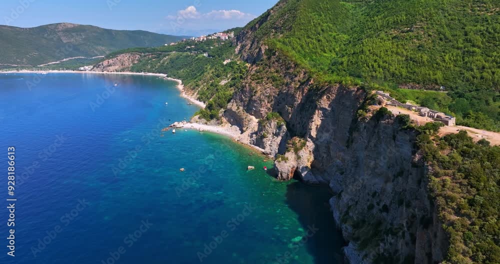 Aerial view passing the Fort Mogren ruins on the coast of Budva, Montenegro Aerial view passing the Fort Mogren ruins on the coast of Budva, Montenegro