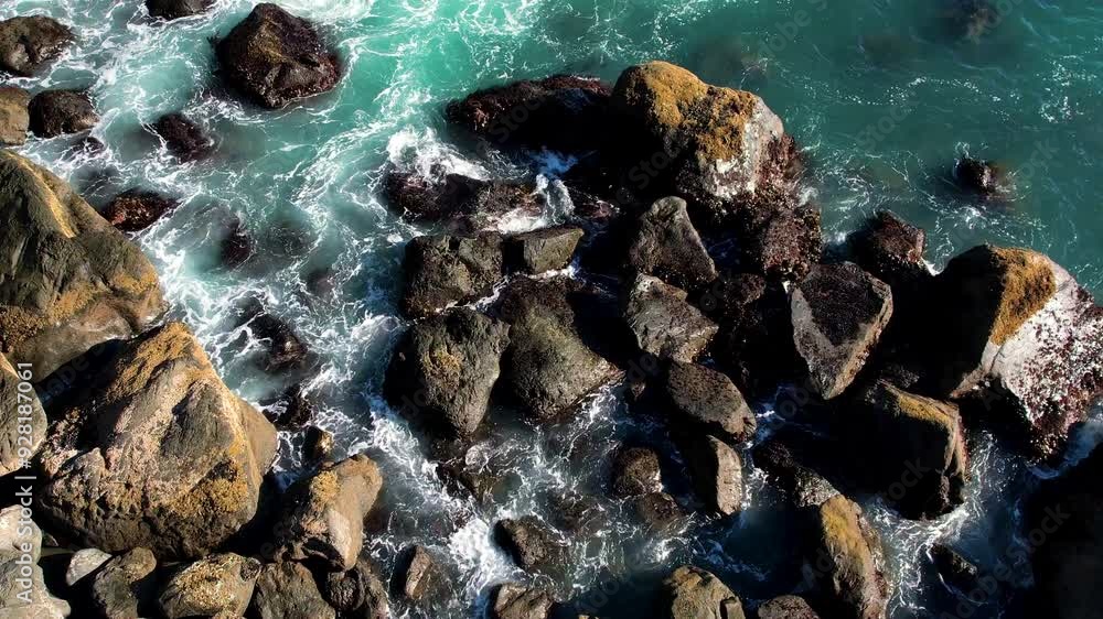 Ocean water waves crashing into rocks. Ocean water waves crashing into rocks.