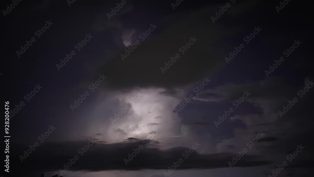 Lightning flashes through dark storm clouds. Black clouds before the thunderstorm. Lightning flashes through dark storm clouds. Black clouds before the thunderstorm.