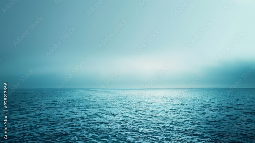 Obraz premium A calming, gradient blue background transitioning from deep ocean blue to a soft, light teal,
