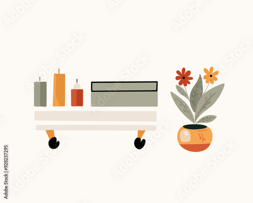 The potted home flower and tea table with decorative candles and box