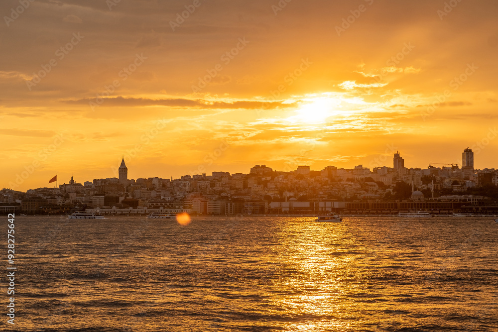 Golden rays of the sun illuminate the Bosphorus as the skyline of Istanbul subtl Golden rays of the sun illuminate the Bosphorus as the skyline of Istanbul subtl