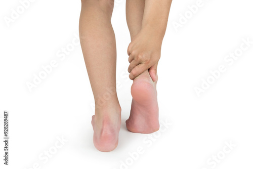 Young woman's hand touching perfectly groomed legs on white background.