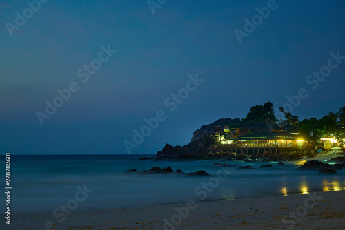 Restaurant illuminating the night on a tropical island photo