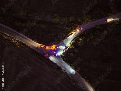 night Fatal road accident. police flashing lights. Roadside assistance loads wrecked car, police officer direct traffic