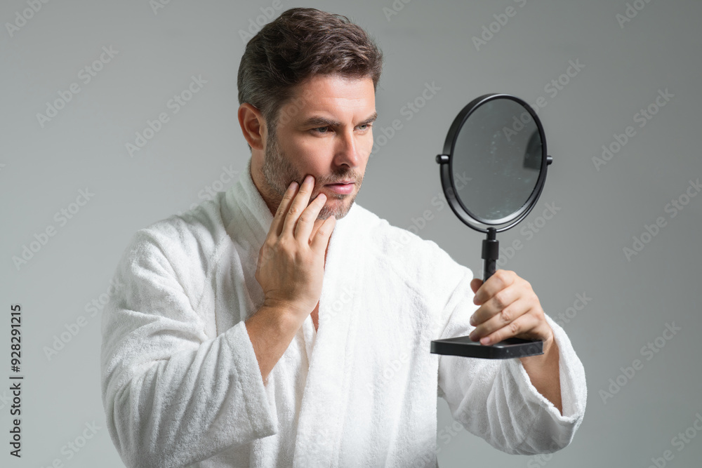 Attractive man with perfect skin touch face after shaving. Skin care healthcare cosmetic procedures concept. Close up man looking in mirror, sensitive skin, cosmetology treatment. Skin care. Attractive man with perfect skin touch face after shaving. Skin care healthcare cosmetic procedures concept. Close up man looking in mirror, sensitive skin, cosmetology treatment. Skin care.
