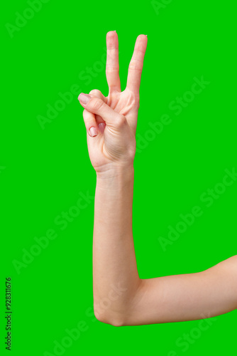 Woman's Hand Making the Peace Sign Against a Green Screen photo