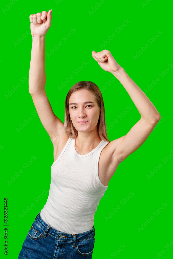 Young Woman Dancing With Arms Raised Against Green Screen Young Woman Dancing With Arms Raised Against Green Screen
