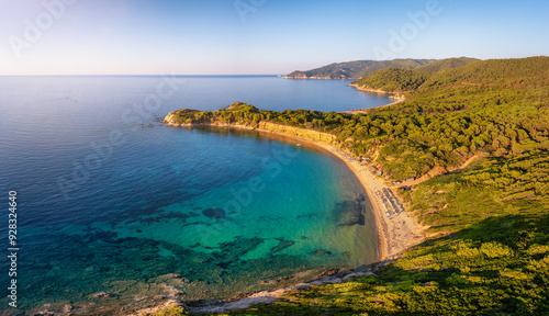 Fototapeta Naklejka Na Ścianę i Meble -  Aerial sunset view of Mantraki beach with emerald sea and lush pine tree forrest at the island of Skiathos, Sporades, Greece