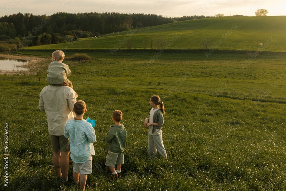 Father with children spending leisure time in nature Father with children spending leisure time in nature