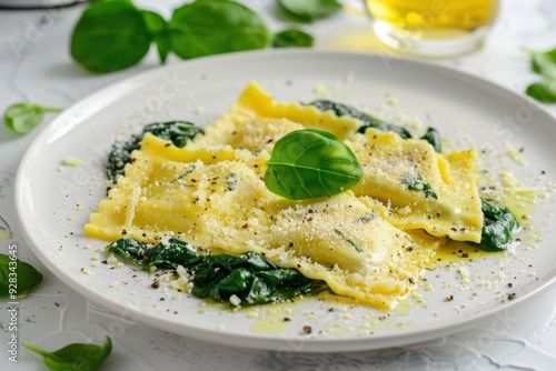 Cheese and spinach ravioli on white plate