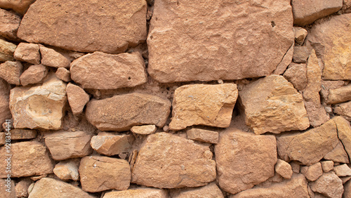 Old stone wall made without cement between the stones