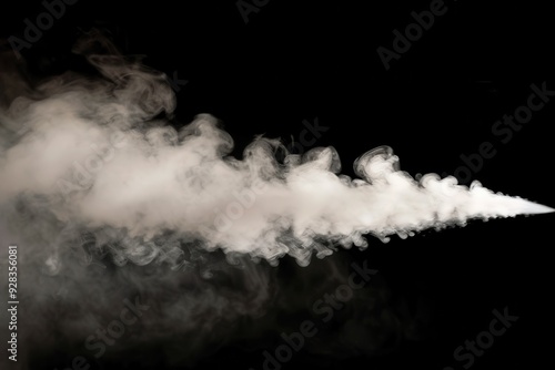 Close up of steam rising from humidifier spray swirling water droplets above black background photo