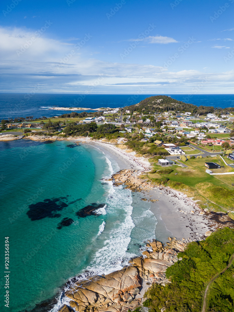 Bicheno, Tasmania: Aerial drone view of the beach at Bicheno coastline with a rainbow close to the famous Coles bay in Tasmania in Australia.