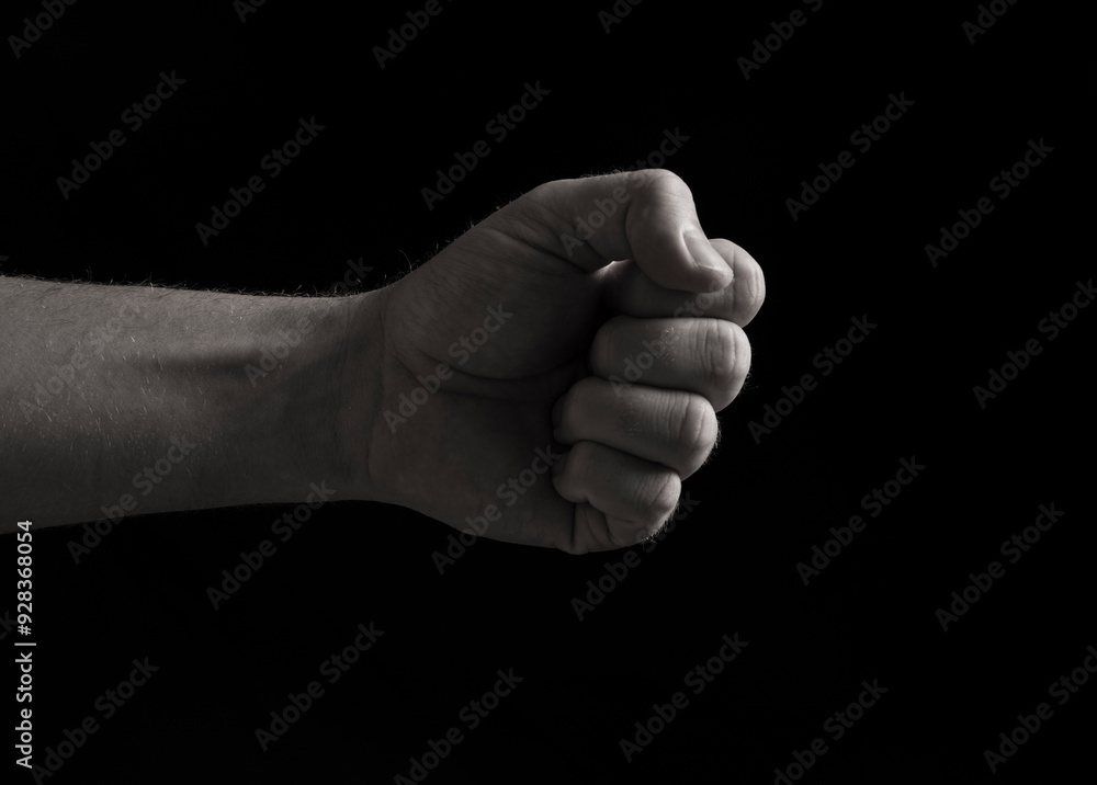 A human fist with a silver hand on the background
A human fist with a silver hand on the background