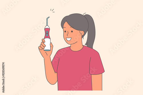 Irrigator for cleaning teeth in hands of woman demonstrating snow-white smile and showing off device