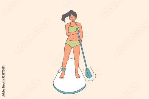 Woman surfer uses SUP board to float down river, and rows paddle to adjust direction